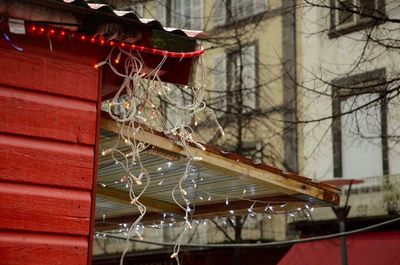 Close-up of red clothes hanging on built structure
