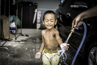 Portrait of happy boy with reflection in water