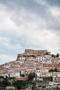 Rocca imperiale. low angle view of buildings against cloudy sky