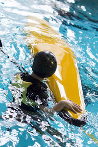 High angle view of boy swimming in pool