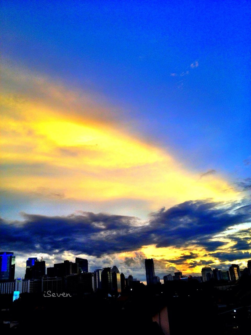 building exterior, architecture, built structure, city, sunset, sky, silhouette, cityscape, blue, cloud - sky, dusk, skyscraper, urban skyline, cloud, building, skyline, residential building, orange color, outdoors, city life