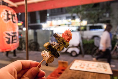 Cropped image of hand holding cigarette