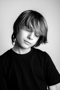 Portrait of cute boy against white background