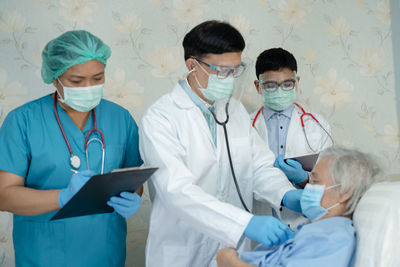 Female doctor examining patient in hospital