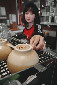 Woman holding drink at home