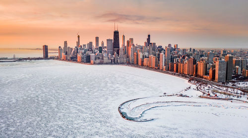 Panoramic shot of modern buildings against sky during sunset