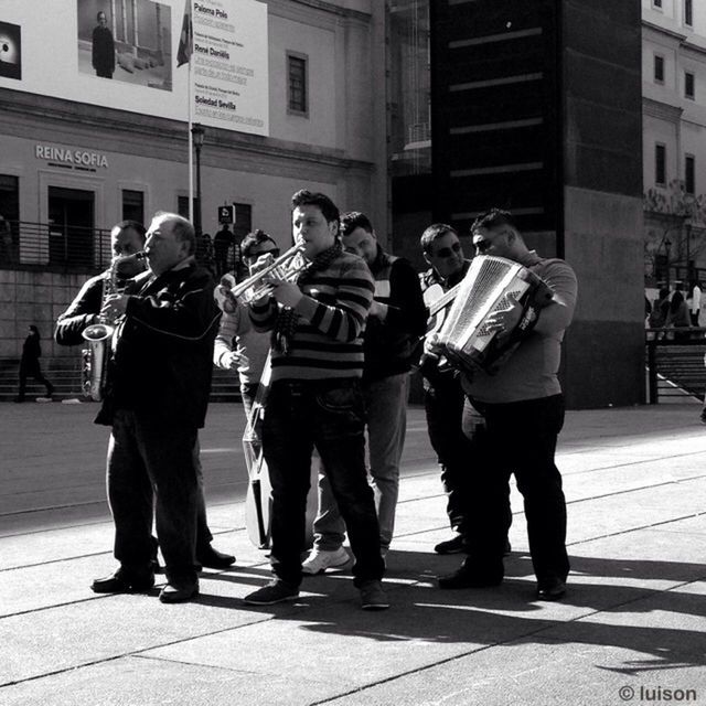 street, lifestyles, togetherness, building exterior, men, city, full length, city life, walking, casual clothing, built structure, architecture, person, leisure activity, bonding, city street, friendship, rear view