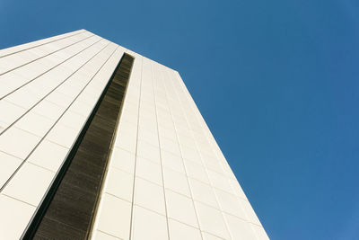 Low angle view of modern building against clear blue sky
