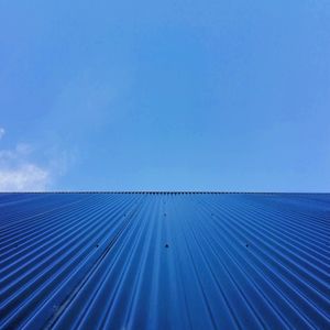Low angle view of roof against blue sky
