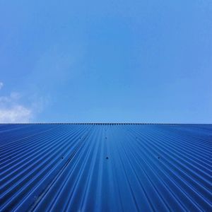 Low angle view of roof against blue sky