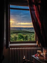 Scenic view of sunset seen through window