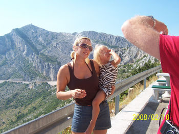 Woman sitting on top of mountain