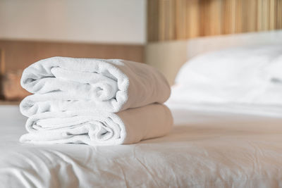 Close-up of towel on bed at hotel