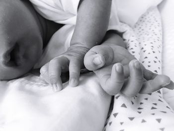 Midsection of baby boy sleeping on bed at home