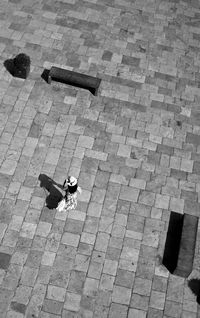 High angle view of woman walking on footpath