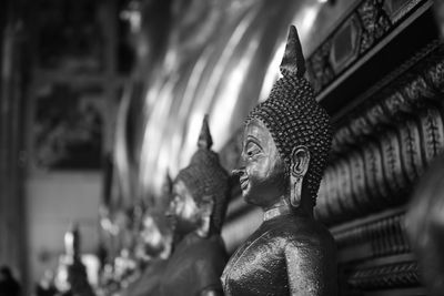 Close-up of buddha statue against building