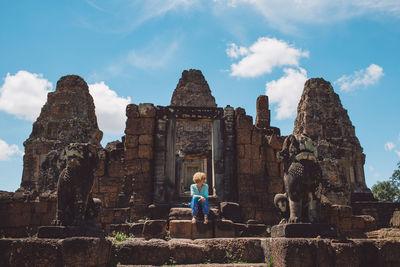 Woman sitting outside temple 