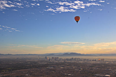 Hot air balloons flying over land