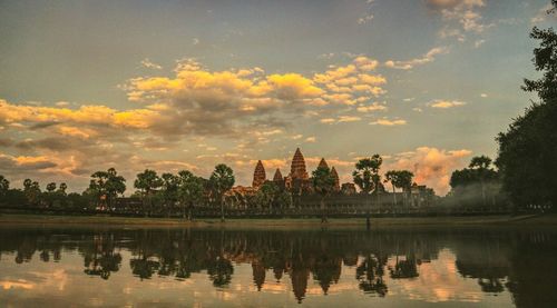 Reflection of trees in lake during sunset