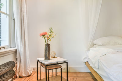 Flower vase on table at home