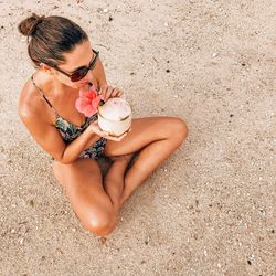 High angle view of woman holding ice cream on beach