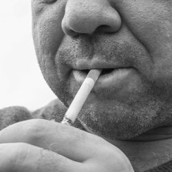 Close-up of mature man burning cigarette