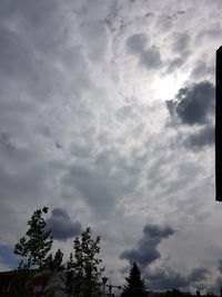 Low angle view of silhouette trees against sky