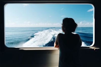 Rear view of man looking at sea