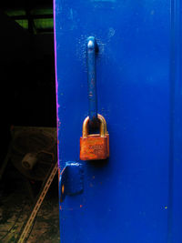 Close-up of padlock on blue door