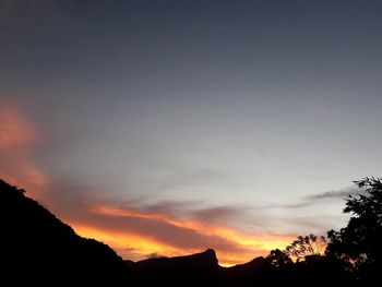 Scenic view of silhouette mountains against sky at sunset