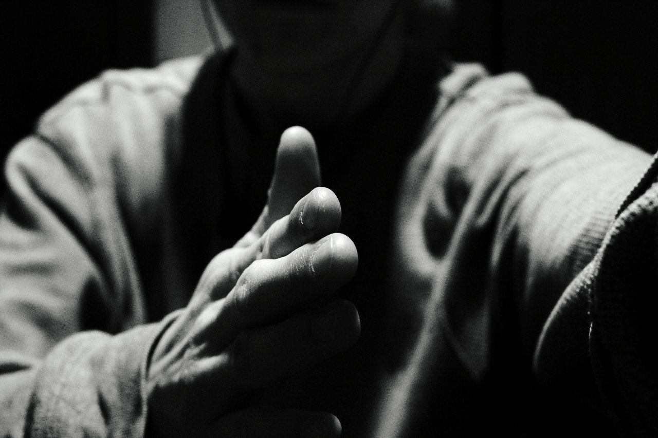 Midsection of man doing karate in dark room