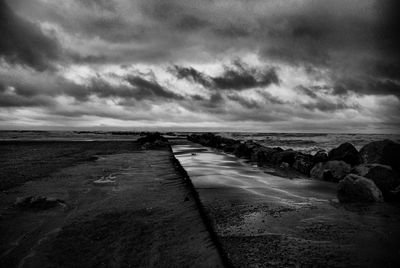 Scenic view of sea against cloudy sky