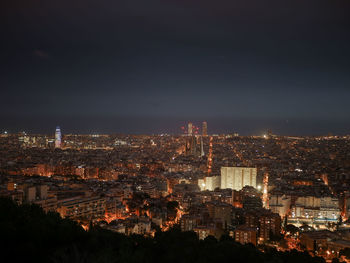 High angle view of illuminated buildings in city at night