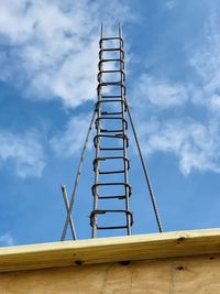 Low angle view of metallic structure against sky