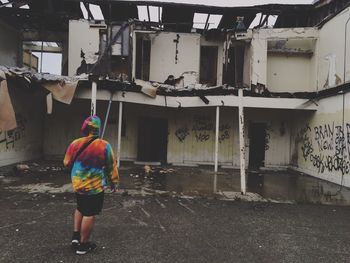 Rear view of  standing in front of old building