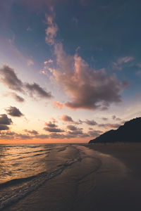 Scenic view of beach against sky during sunset