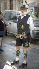 Full length of man standing on street in city