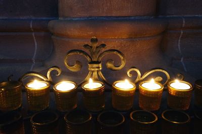 Lit candles in dark room