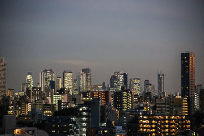 View of skyscrapers lit up at night