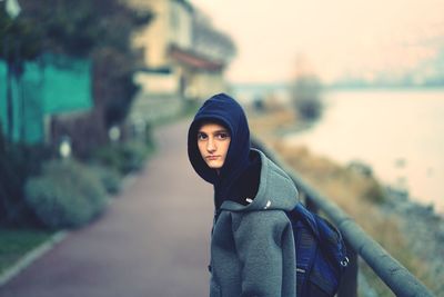 Portrait of woman standing against trees