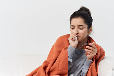 Young woman looking away while using smart phone