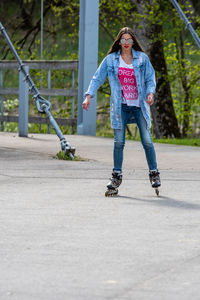 Full length of man skateboarding on footpath