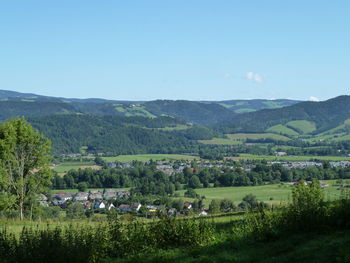 Scenic view of field and mountains against sky