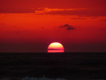 Scenic view of sea against romantic sky at sunset