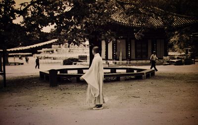 Rear view of woman sitting on bench