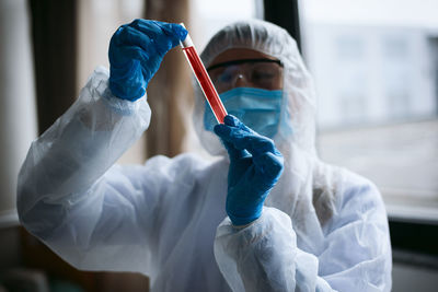 Cropped hand of scientist holding dental equipment