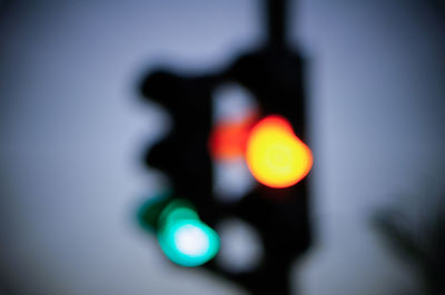 Close-up of road sign against sky during sunset