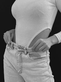 Midsection of woman wearing jeans