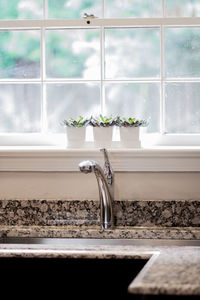 Close-up of faucet and sink in kitchen