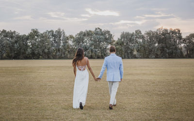 Couple walking on field